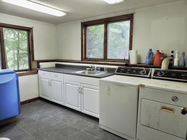 181 Scotland Rd, Sprague, CT 06330 - washroom with washing machine and dryer, cabinet space, dark tile patterned floors, and a textured ceiling