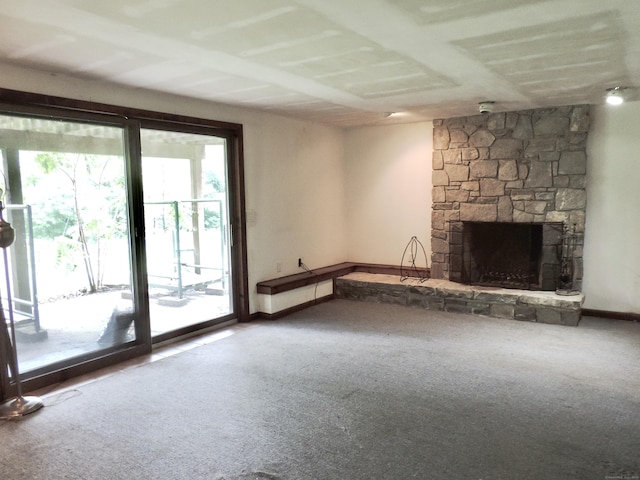 181 Scotland Rd, Sprague, CT 06330 - unfurnished living room with carpet floors and a stone fireplace