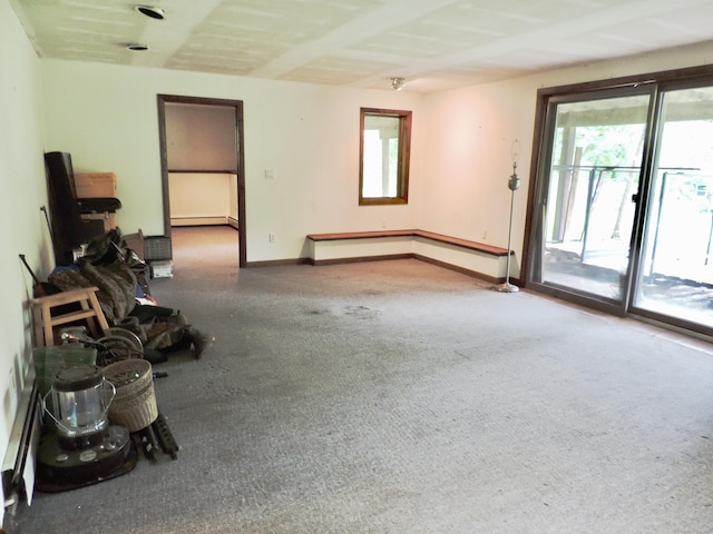 181 Scotland Rd, Sprague, CT 06330 - unfurnished living room with healthy amount of natural light, a baseboard heating unit, and carpet flooring
