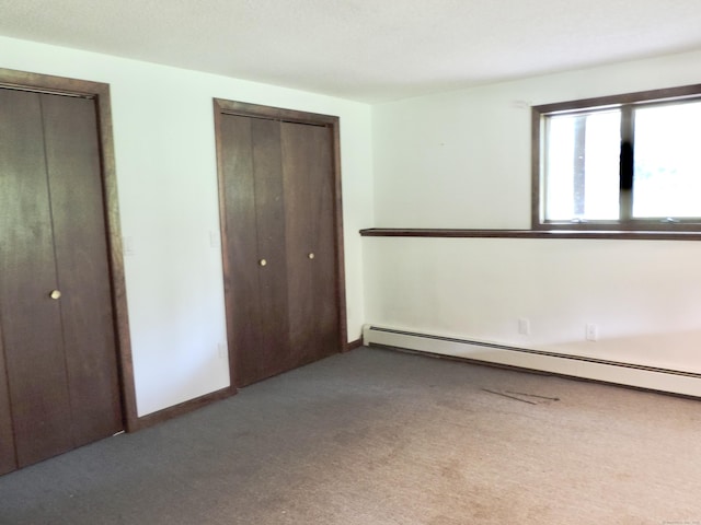 181 Scotland Rd, Sprague, CT 06330 - unfurnished bedroom with baseboard heating, carpet floors, and multiple closets