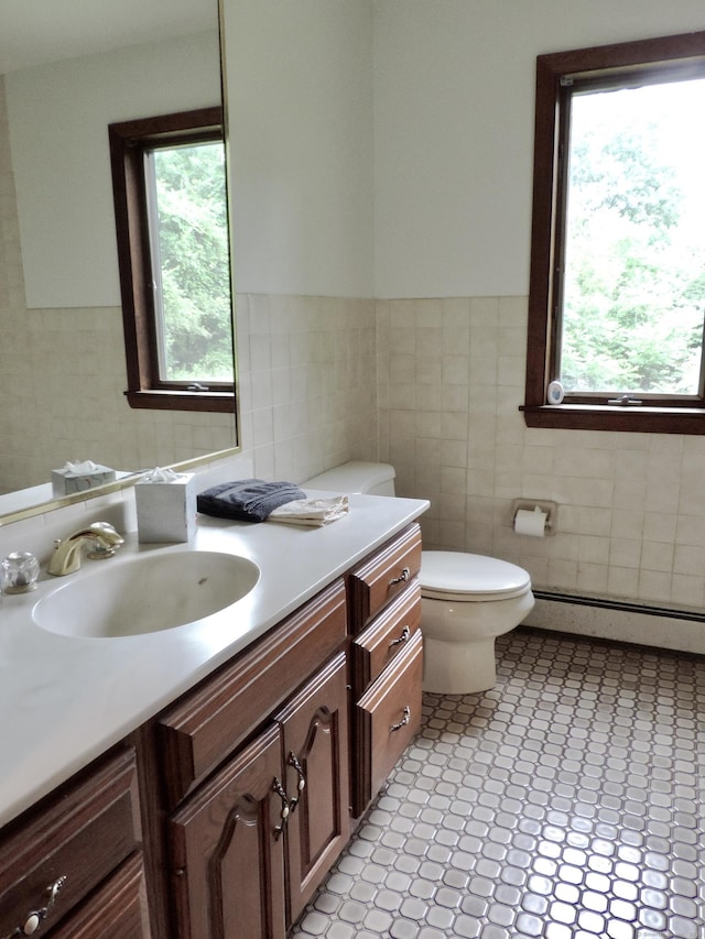 181 Scotland Rd, Sprague, CT 06330 - bathroom with baseboard heating, tile walls, vanity, and a wainscoted wall