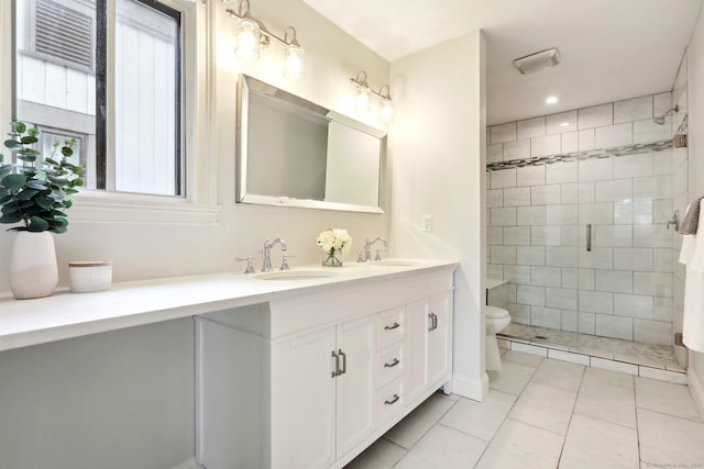 bathroom with tile patterned flooring, vanity, a shower with shower door, and toilet