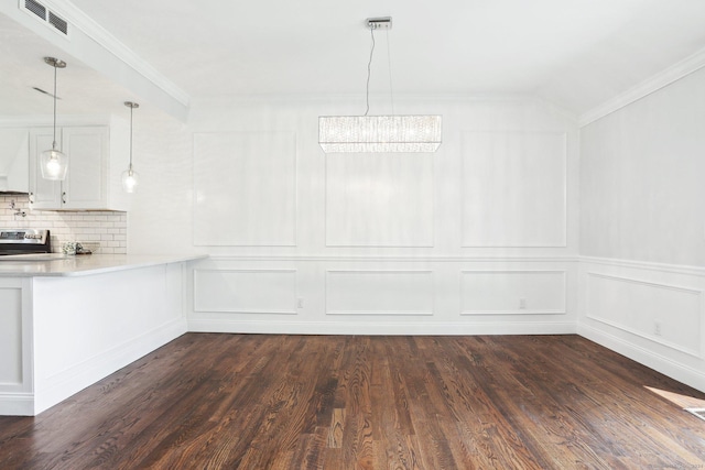 unfurnished dining area with dark wood-type flooring and ornamental molding