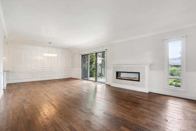 unfurnished living room featuring dark hardwood / wood-style flooring, ornamental molding, and lofted ceiling