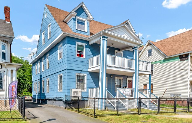 view of front facade with a balcony and covered porch