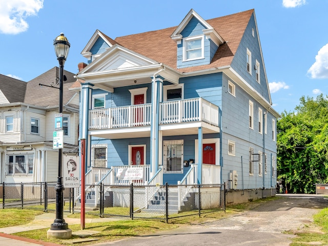 view of front of home featuring a balcony and covered porch