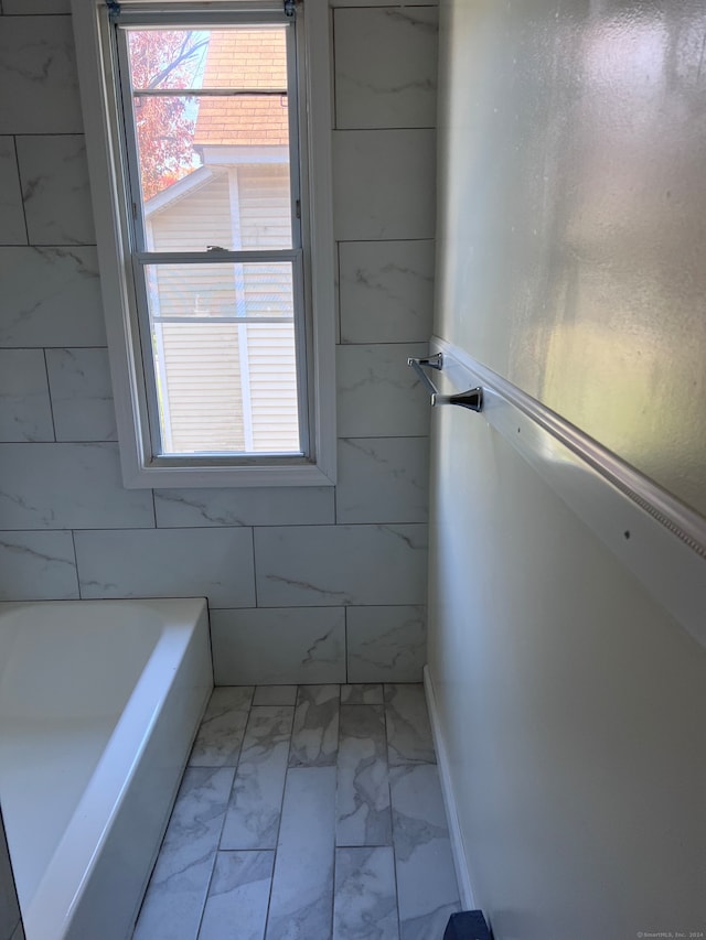 bathroom featuring plenty of natural light and tile patterned flooring