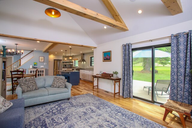 living room with beam ceiling, a notable chandelier, light wood-type flooring, and high vaulted ceiling