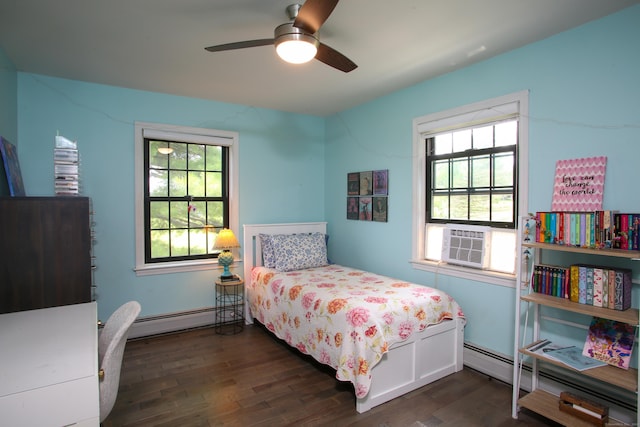 bedroom with dark wood-type flooring, baseboard heating, multiple windows, and ceiling fan