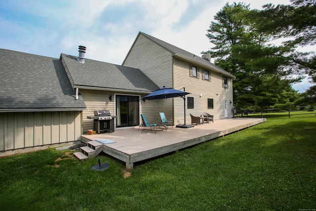 back of house with a wooden deck and a lawn