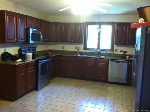 kitchen with light tile patterned floors, stainless steel appliances, sink, and ceiling fan