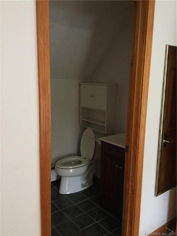 bathroom featuring tile patterned floors, vanity, and toilet