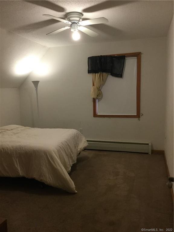 bedroom with carpet flooring, vaulted ceiling, a baseboard radiator, and ceiling fan