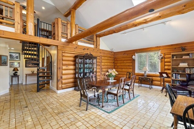 584 Prospect St, Woodstock, CT 06281 - dining area featuring high vaulted ceiling, stairway, log walls, and brick patterned floor