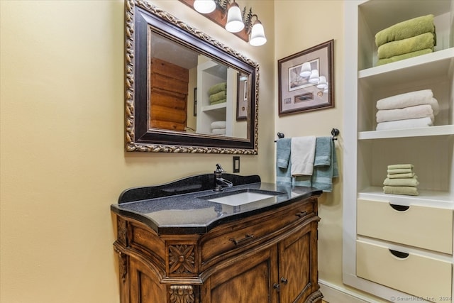 bathroom with built in features and vanity