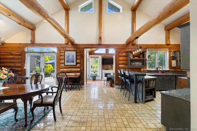 584 Prospect St, Woodstock, CT 06281 - dining room with high vaulted ceiling, rustic walls, beamed ceiling, and a fireplace