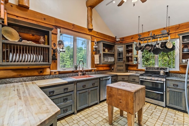 kitchen with light tile patterned floors, stainless steel appliances, sink, and ceiling fan