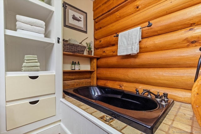 bathroom featuring a bathing tub and tile patterned flooring