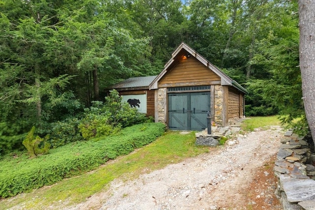 584 Prospect St, Woodstock, CT 06281 - garage featuring a wooded view