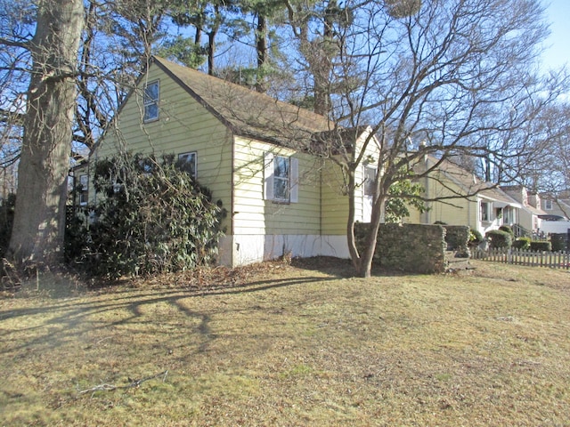 view of side of property with a lawn