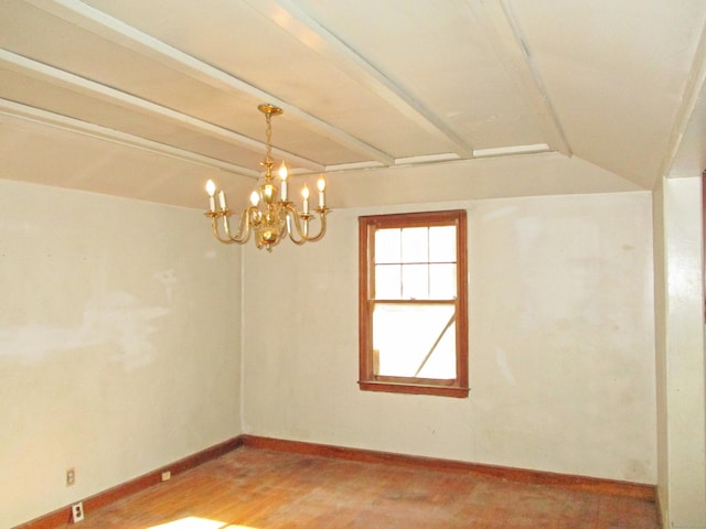 empty room featuring lofted ceiling with beams and a notable chandelier