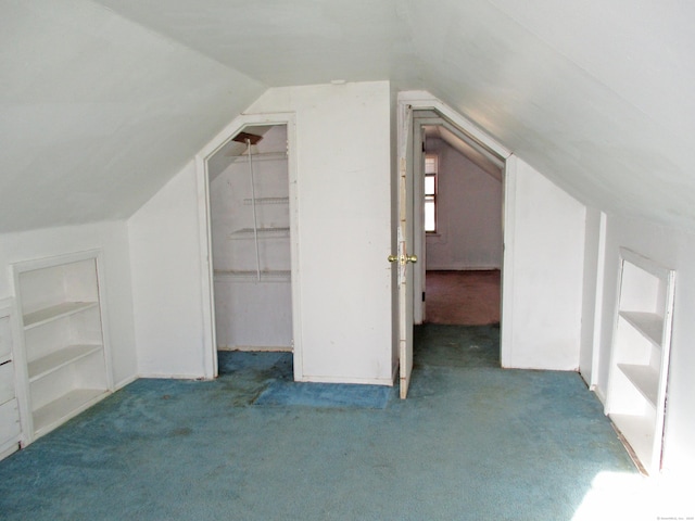 bonus room with carpet flooring, built in features, and vaulted ceiling