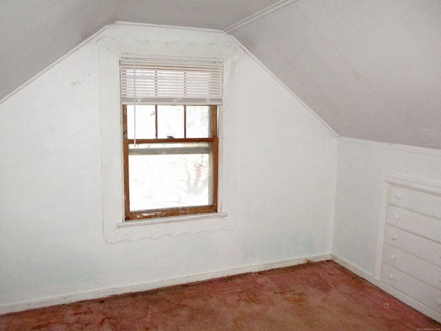 bonus room with carpet floors and vaulted ceiling