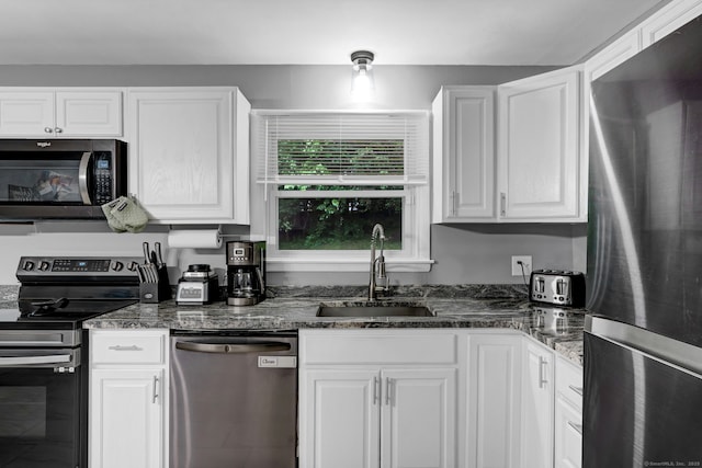 207 Jepson Ln, Meriden, CT 06451 - kitchen featuring stainless steel appliances, a sink, white cabinetry, and dark stone counters