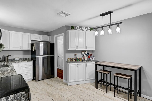 207 Jepson Ln, Meriden, CT 06451 - kitchen featuring freestanding refrigerator, black electric range, light stone countertops, and white cabinets