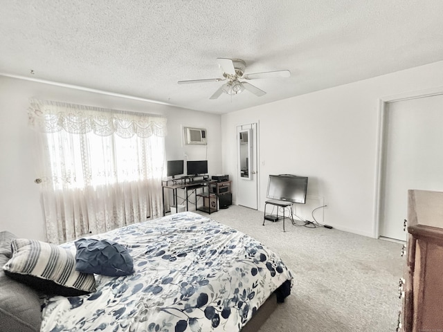 carpeted bedroom featuring ceiling fan, a wall mounted air conditioner, and a textured ceiling