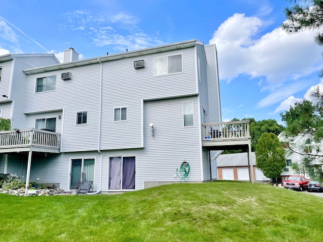 back of house with a wooden deck, a yard, and a garage