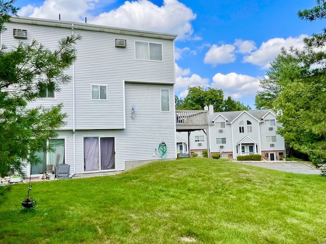 back of property featuring a lawn