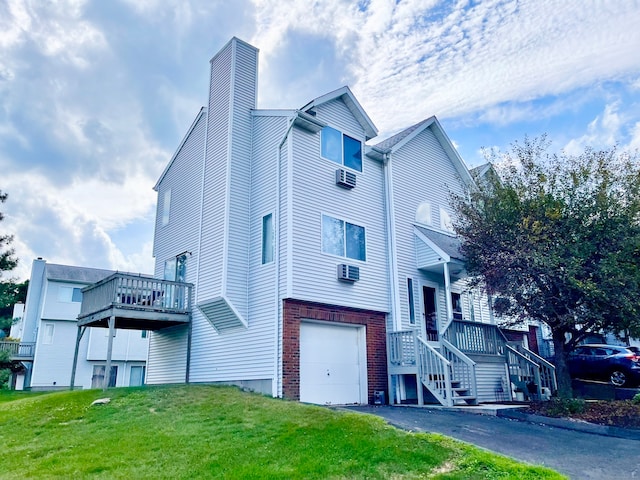 view of side of property with a garage and a yard