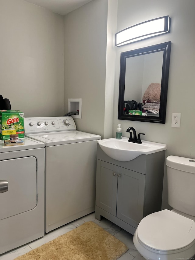 interior space featuring vanity, independent washer and dryer, and toilet