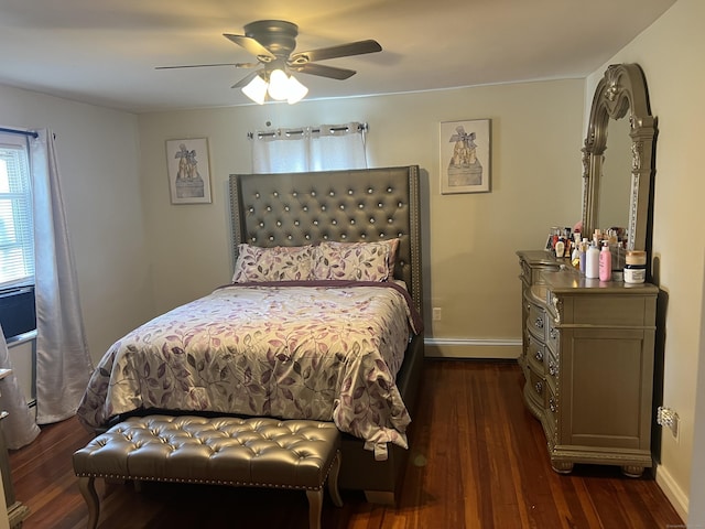 bedroom with ceiling fan, dark hardwood / wood-style floors, and a baseboard heating unit