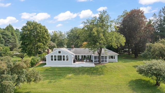 back of property featuring a patio area and a yard