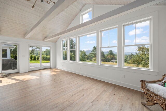 unfurnished sunroom with lofted ceiling with beams and plenty of natural light