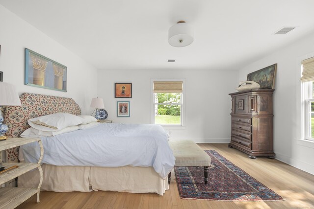 bedroom featuring light wood-type flooring and multiple windows