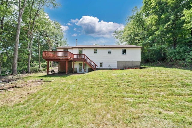 back of house featuring a wooden deck and a lawn