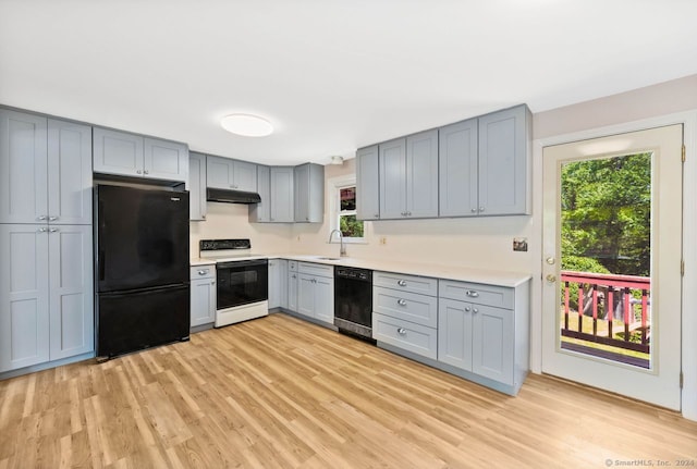 kitchen featuring gray cabinets, sink, light hardwood / wood-style floors, and black appliances