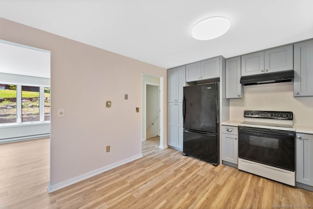 kitchen featuring gray cabinetry, a baseboard heating unit, range with electric cooktop, black fridge, and light wood-type flooring