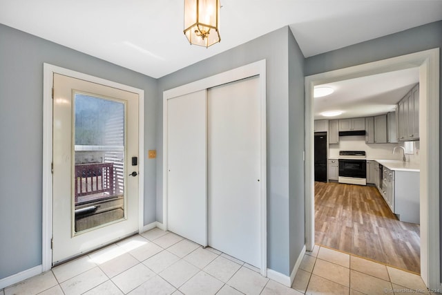 tiled foyer entrance featuring sink