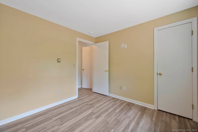 unfurnished bedroom with light wood-type flooring