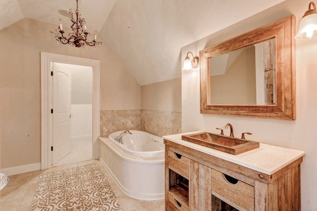 bathroom featuring vanity, vaulted ceiling, tile patterned floors, and a washtub