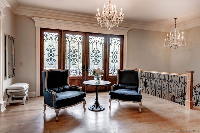 sitting room with french doors, light hardwood / wood-style flooring, and plenty of natural light