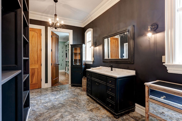 bathroom with vanity, crown molding, and a chandelier