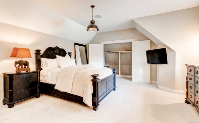 carpeted bedroom with a closet and lofted ceiling