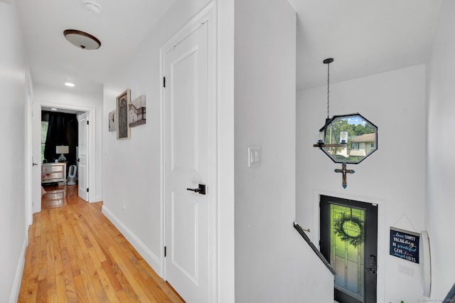 corridor with hardwood / wood-style floors