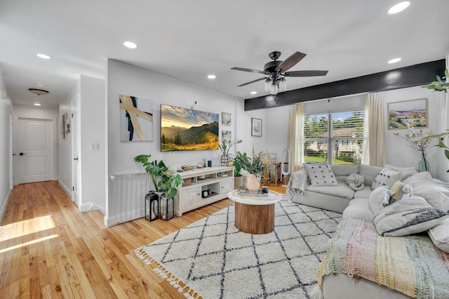 living room featuring light hardwood / wood-style floors and ceiling fan