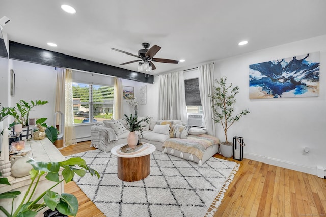 living room featuring cooling unit, ceiling fan, light hardwood / wood-style floors, and a baseboard heating unit